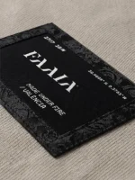 Parche textil con el logo de Faaia y tela fallera damasco color negro.