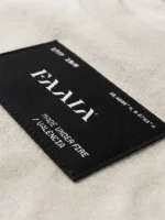 Etiqueta textil con logo faaia moda.